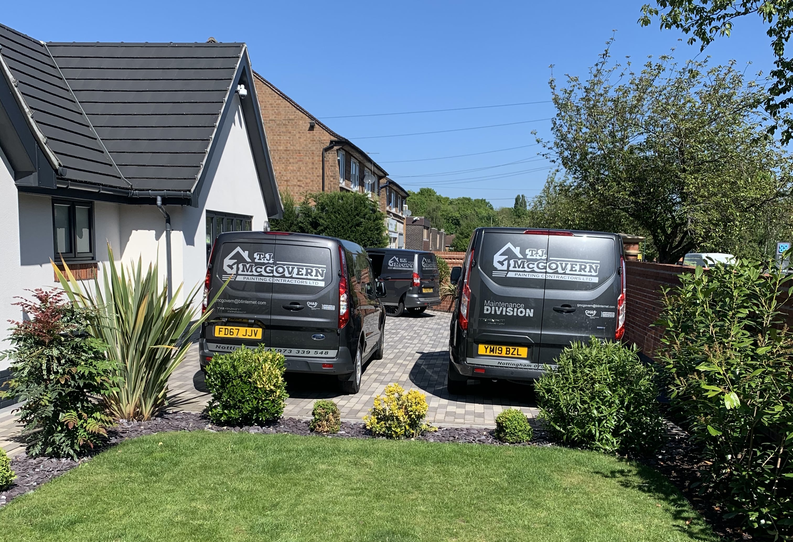 back of parked vans with T J stickers on back